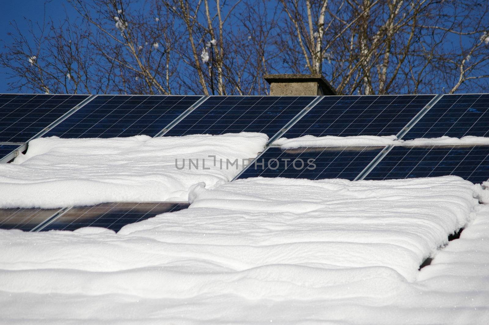 solar cells on a snowy roof