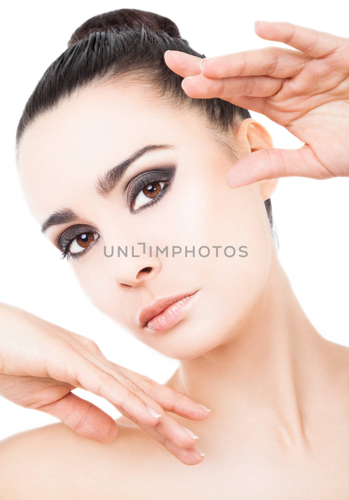 Portrait of beautiful woman with hands raised next to face