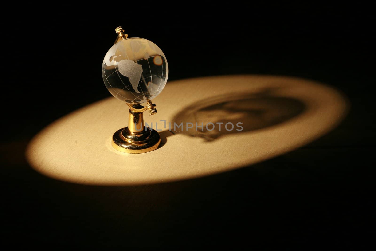 a glass globe in dramatic lighting............