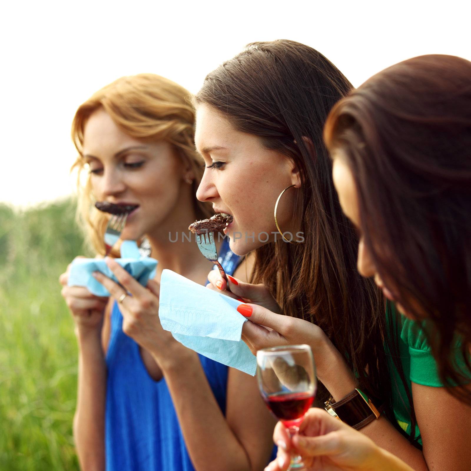 girls drink wine on nature background