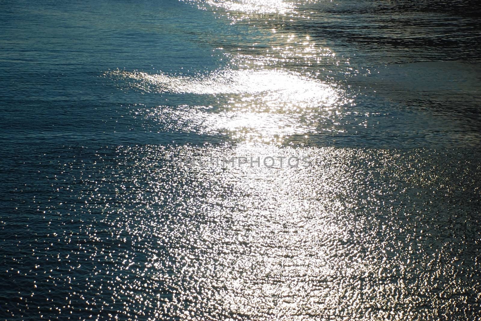 Close-up view of the blue sea with reflections of sun rays