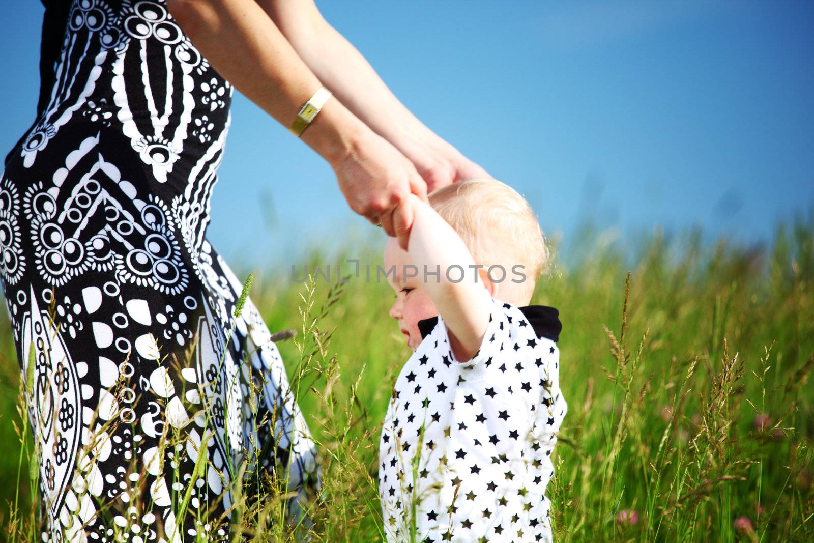 mother and take son by hands in field
