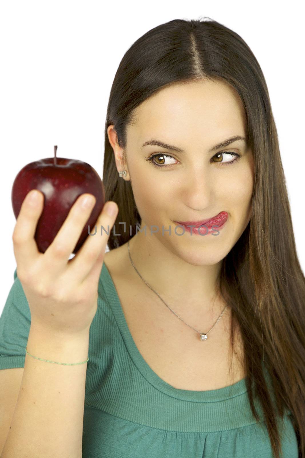 Young female model observing intense a big red apple ready to eat it