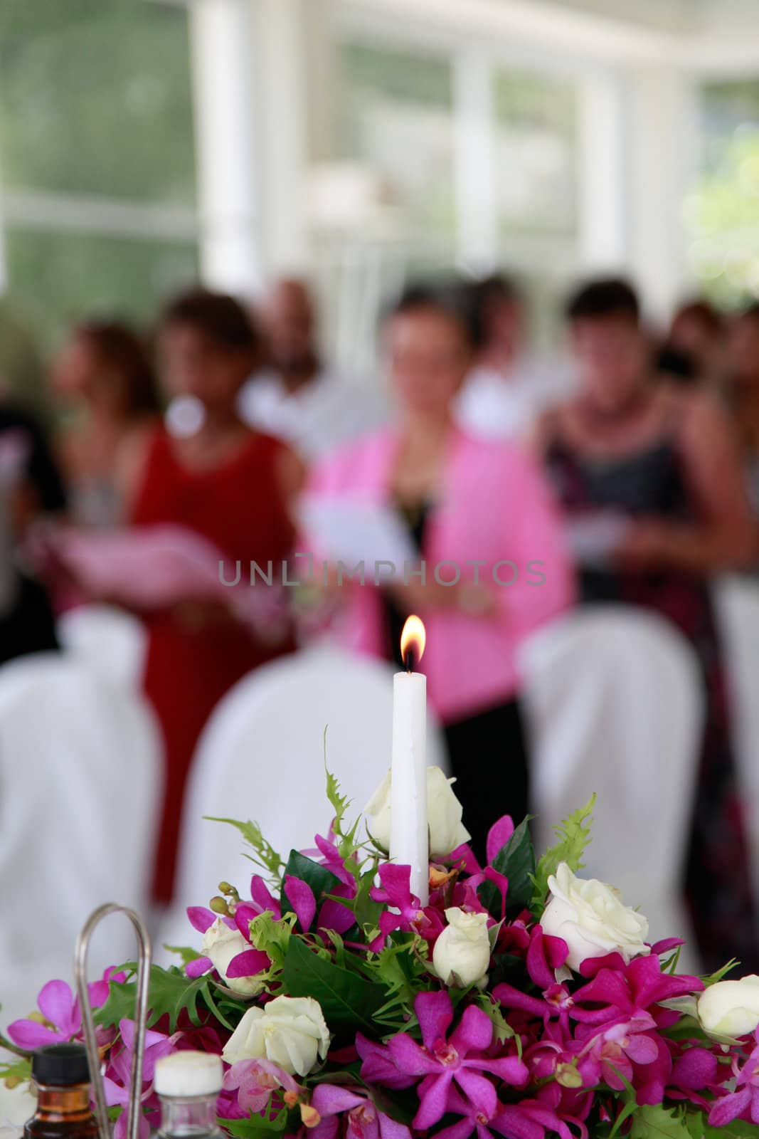 Candle burning during a wedding ceremony inside a church.