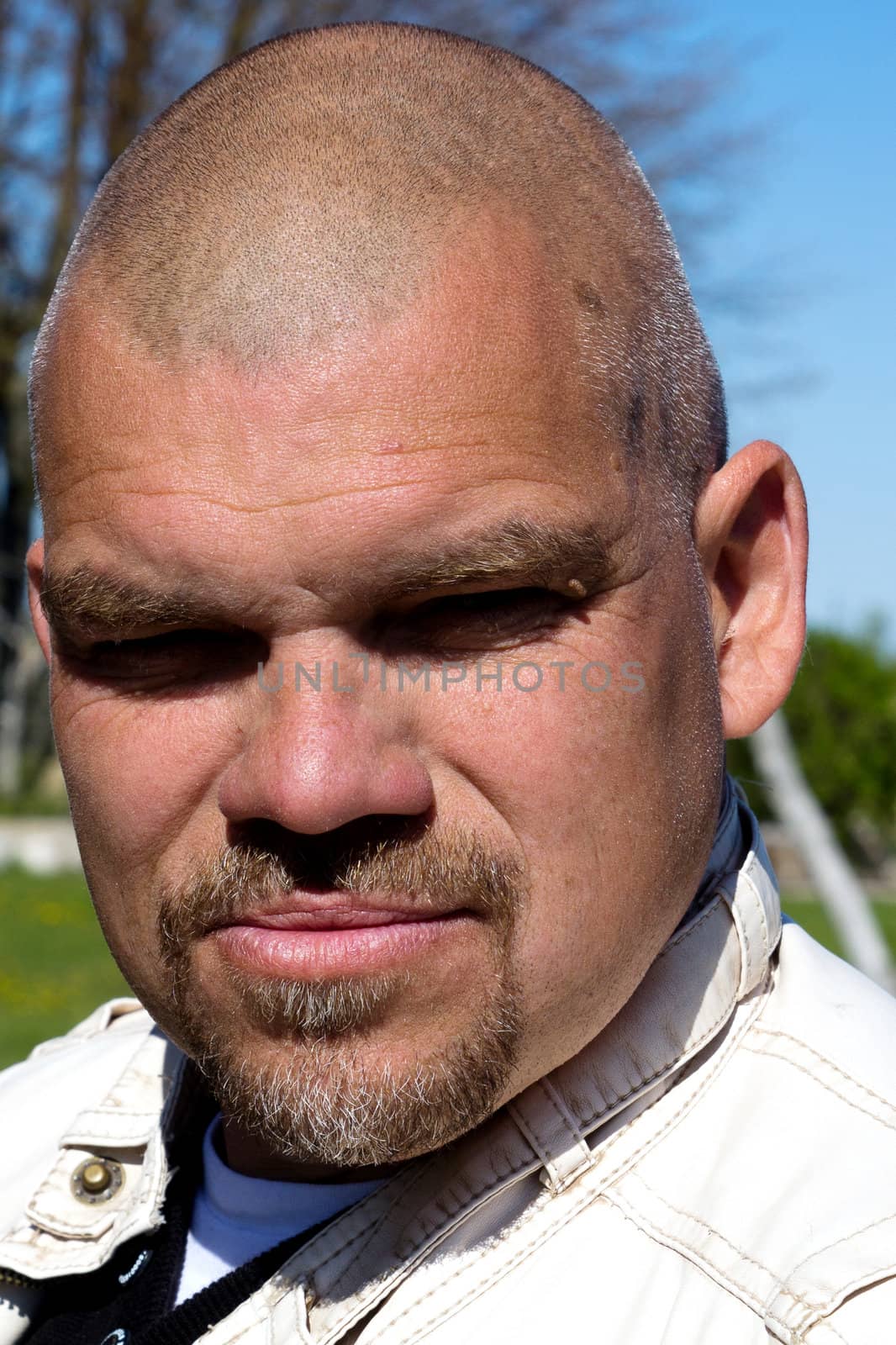 serious real man portrait taken in outdoors 
