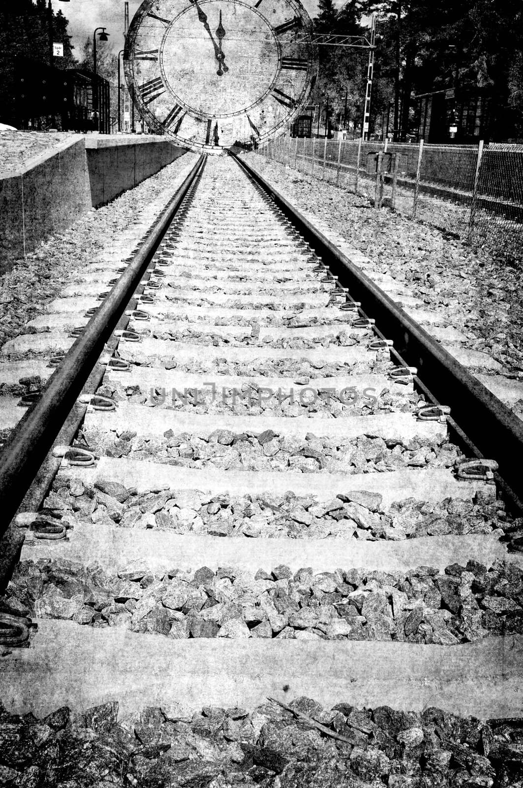 Railroad track in black and white is leading in to a clock, montage in grunge.