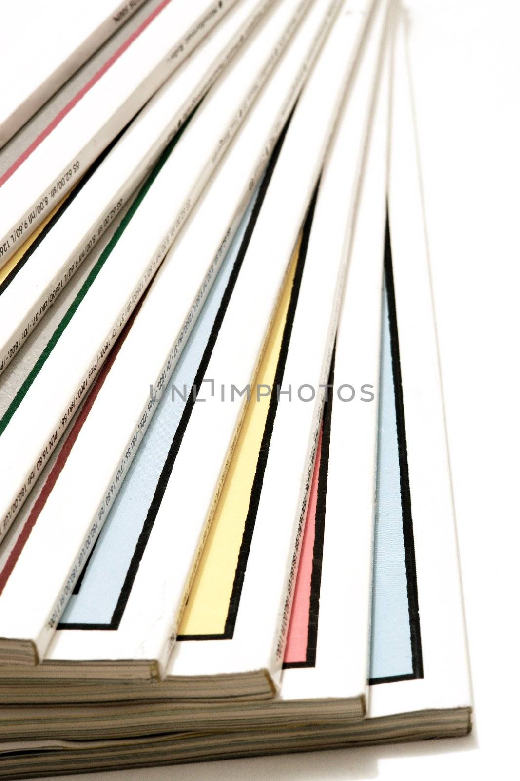 All names and logos are removed the rest of text is just the price of the magazine in differnt currencies!.close-up of magazines/newspapers on a white background.