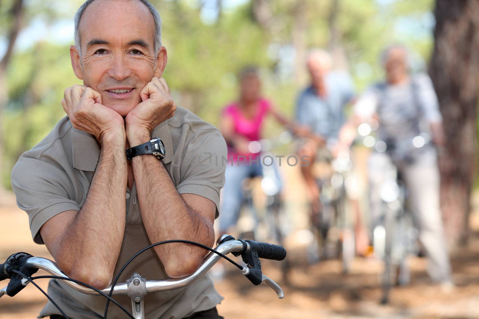 Senior man on a bike by phovoir