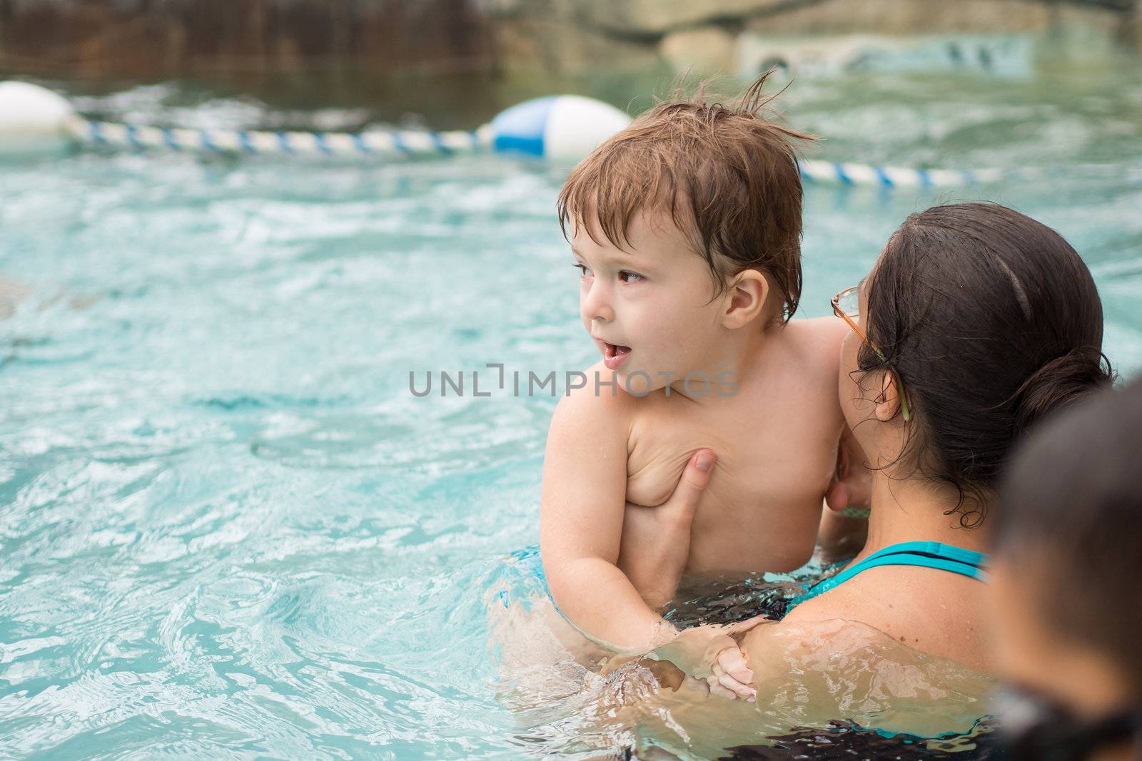 Family playing in the pool by Talanis
