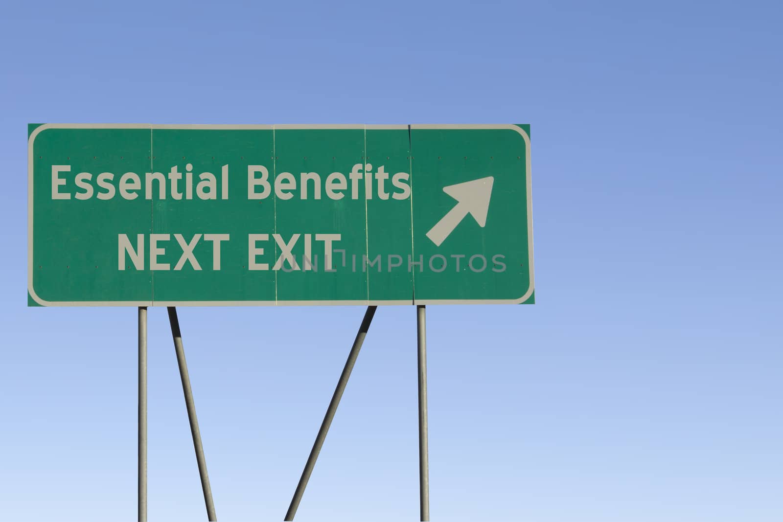 Green road sign with a blue sky gradient background.