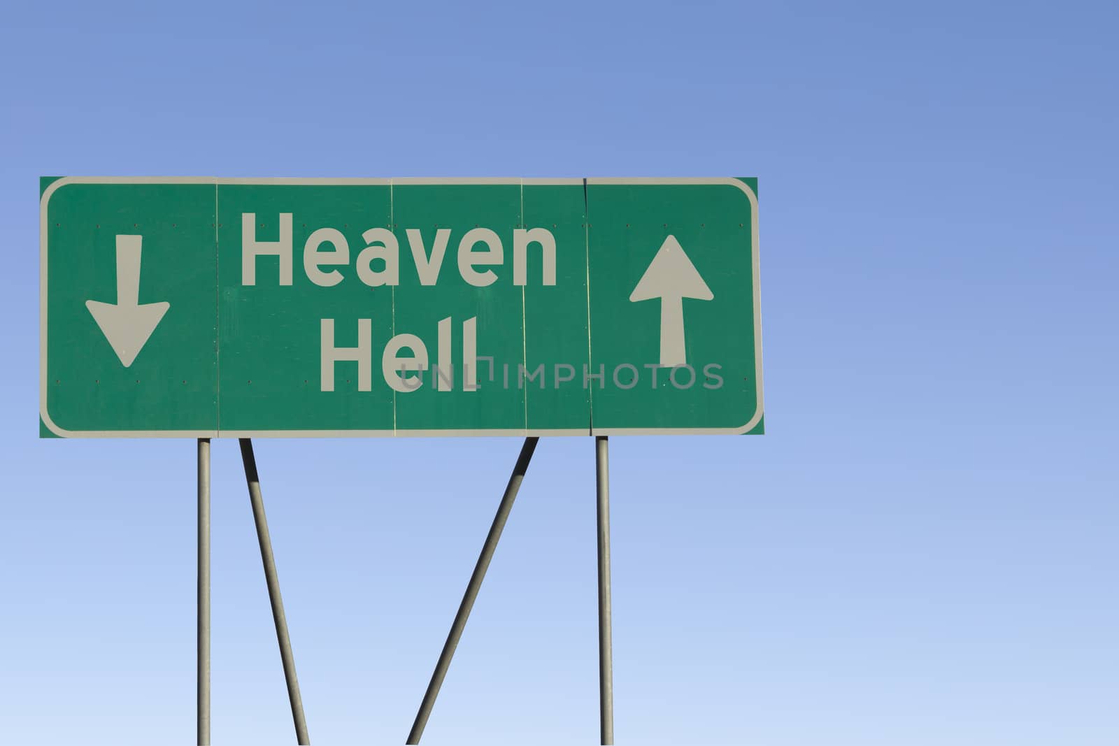 Green road sign with a blue sky gradient background.