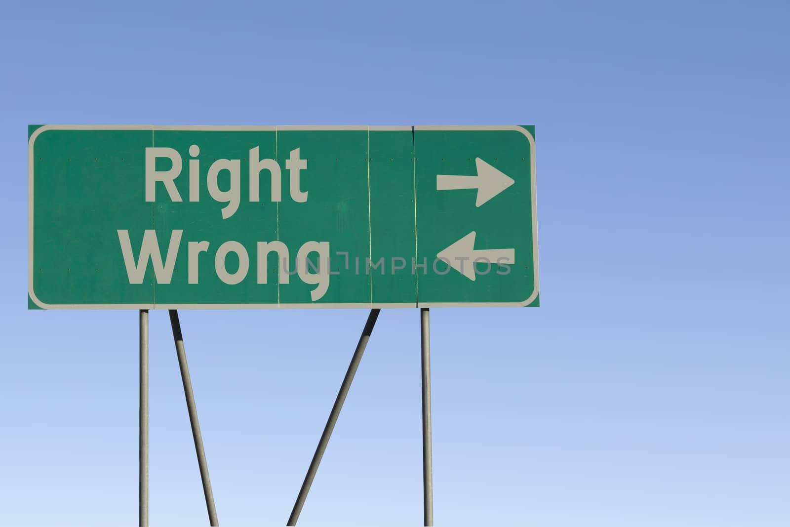 Green road sign with a blue sky gradient background.
