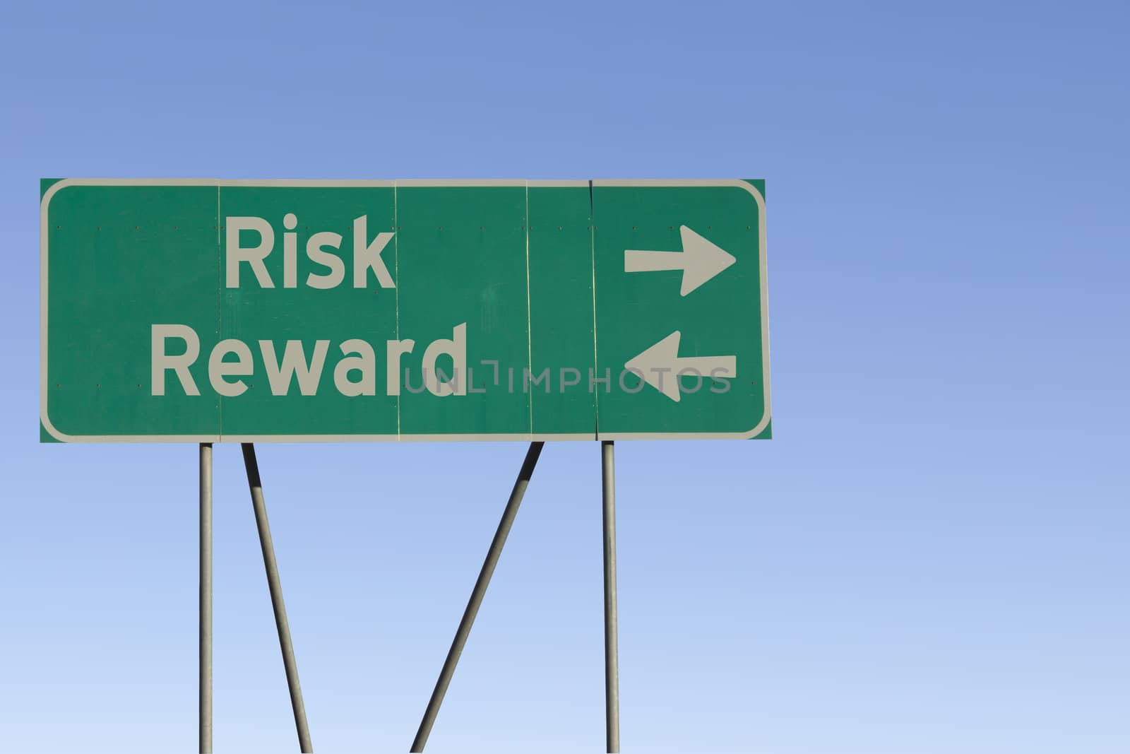 Green road sign with a blue sky gradient background.