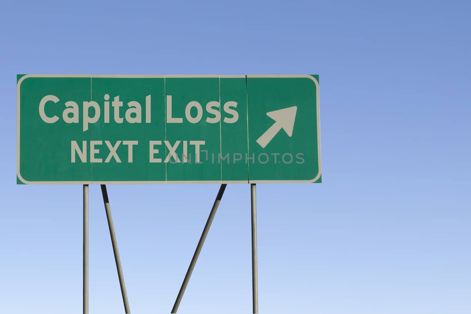 Green road sign with a blue sky gradient background.