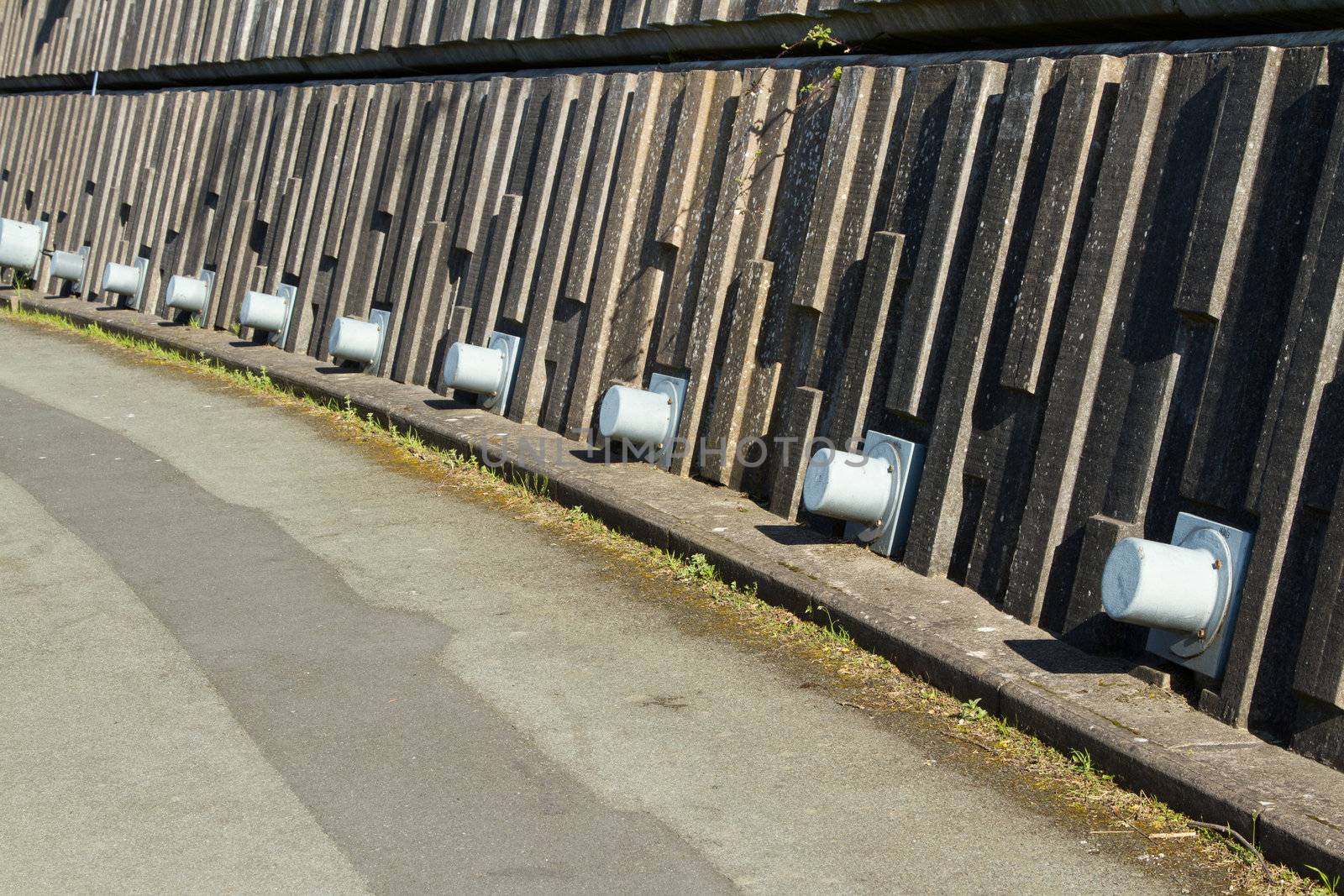 A retaining wall made from precast concrete sections with pins giving structural support.