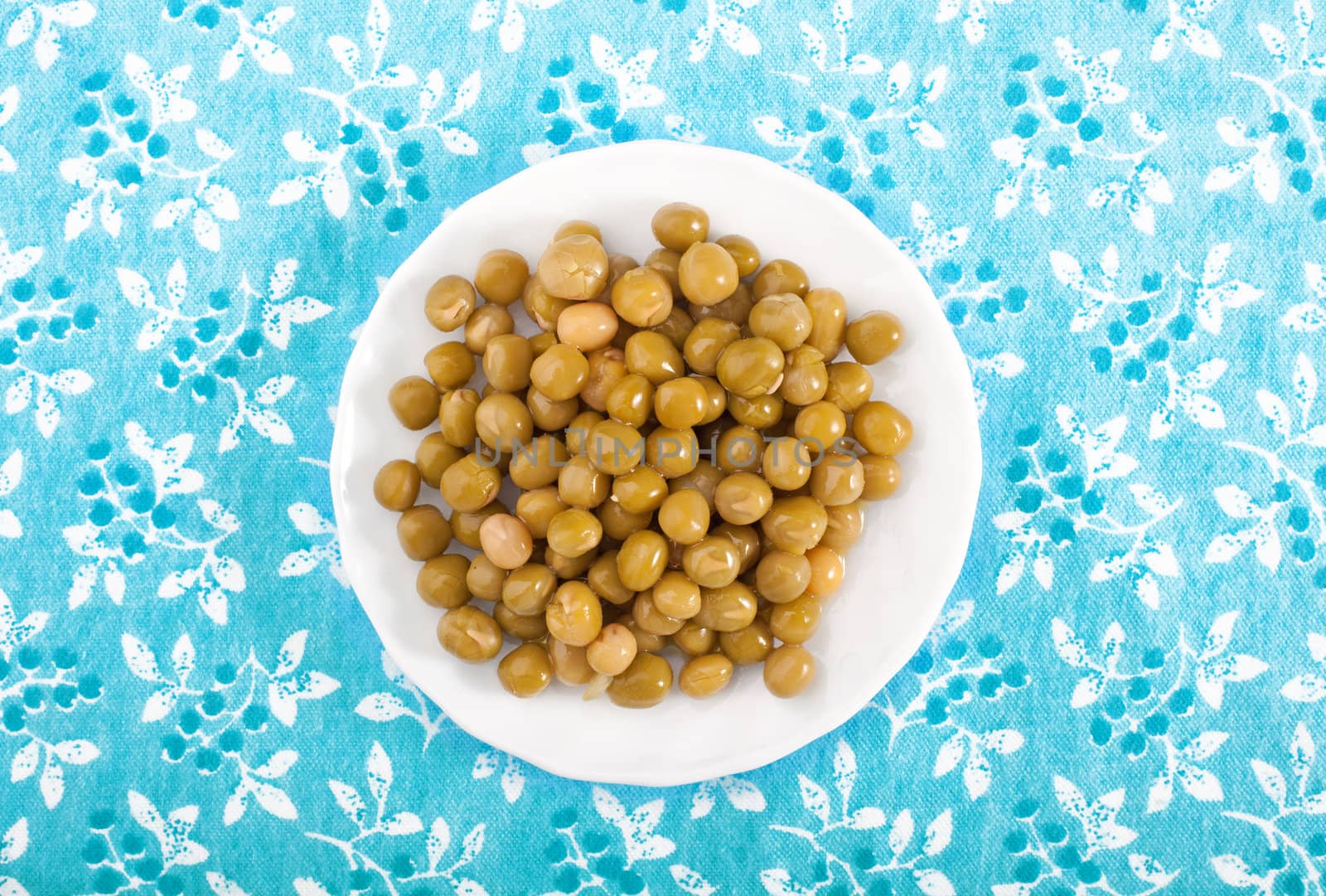 Boiled peas on a blue floral tablecloth