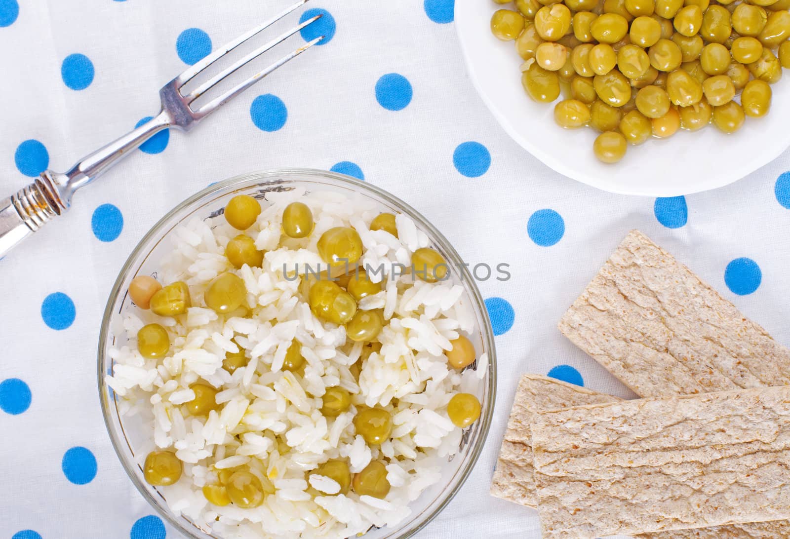 Boiled rice with peas on a polka-dot tablecloth