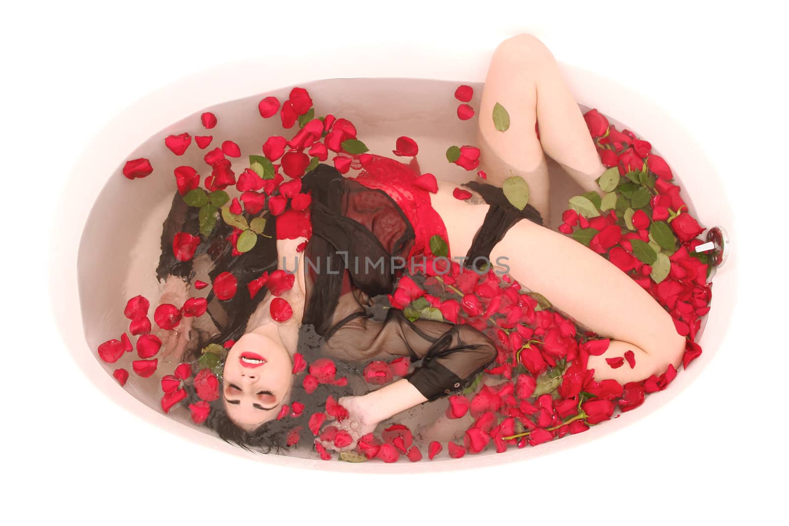 Beautiful Woman in a Bath Tub Full of Flowers