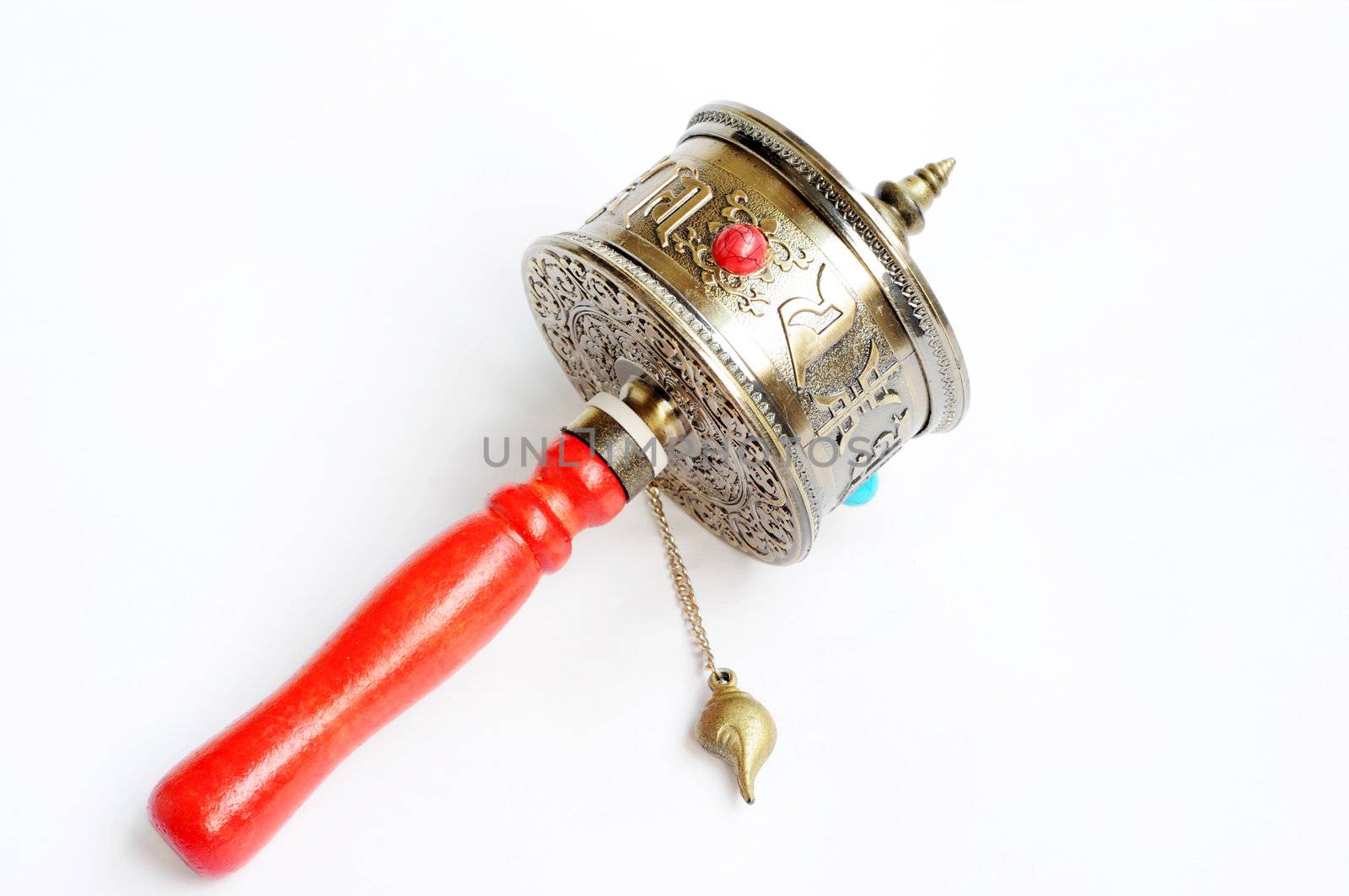 Copper Tibetan prayer wheel on a white background,used as buddhist instrument or souvenir. 