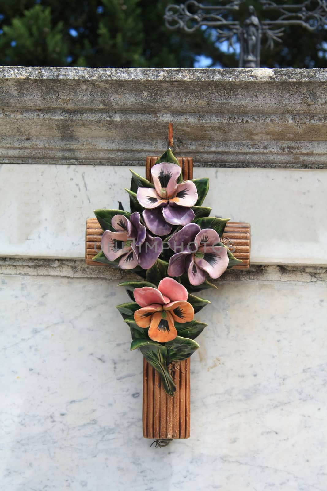 Ceramic flowers on a grave ornament in the Provence, France