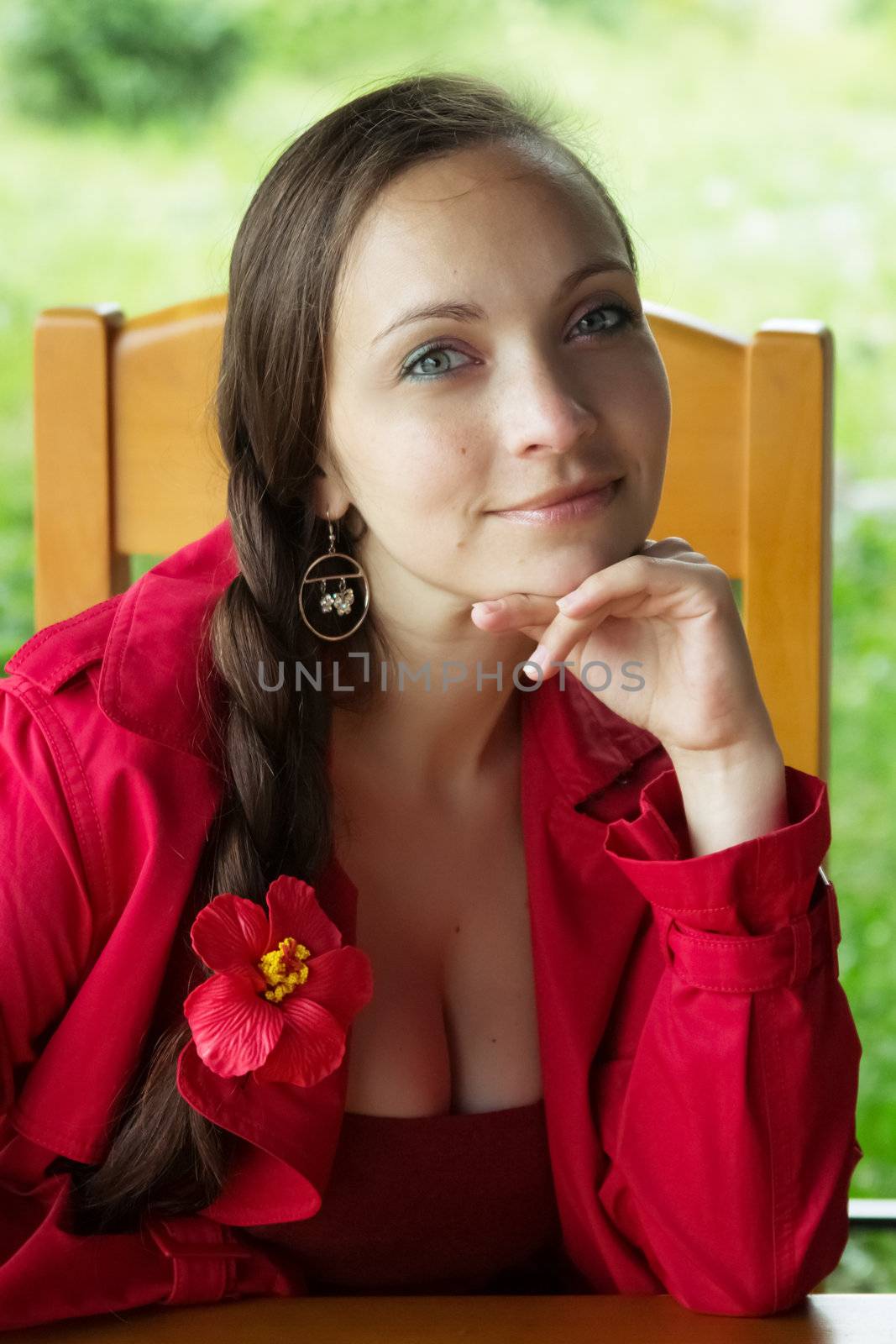 Brunette woman with plait sitting in cafe