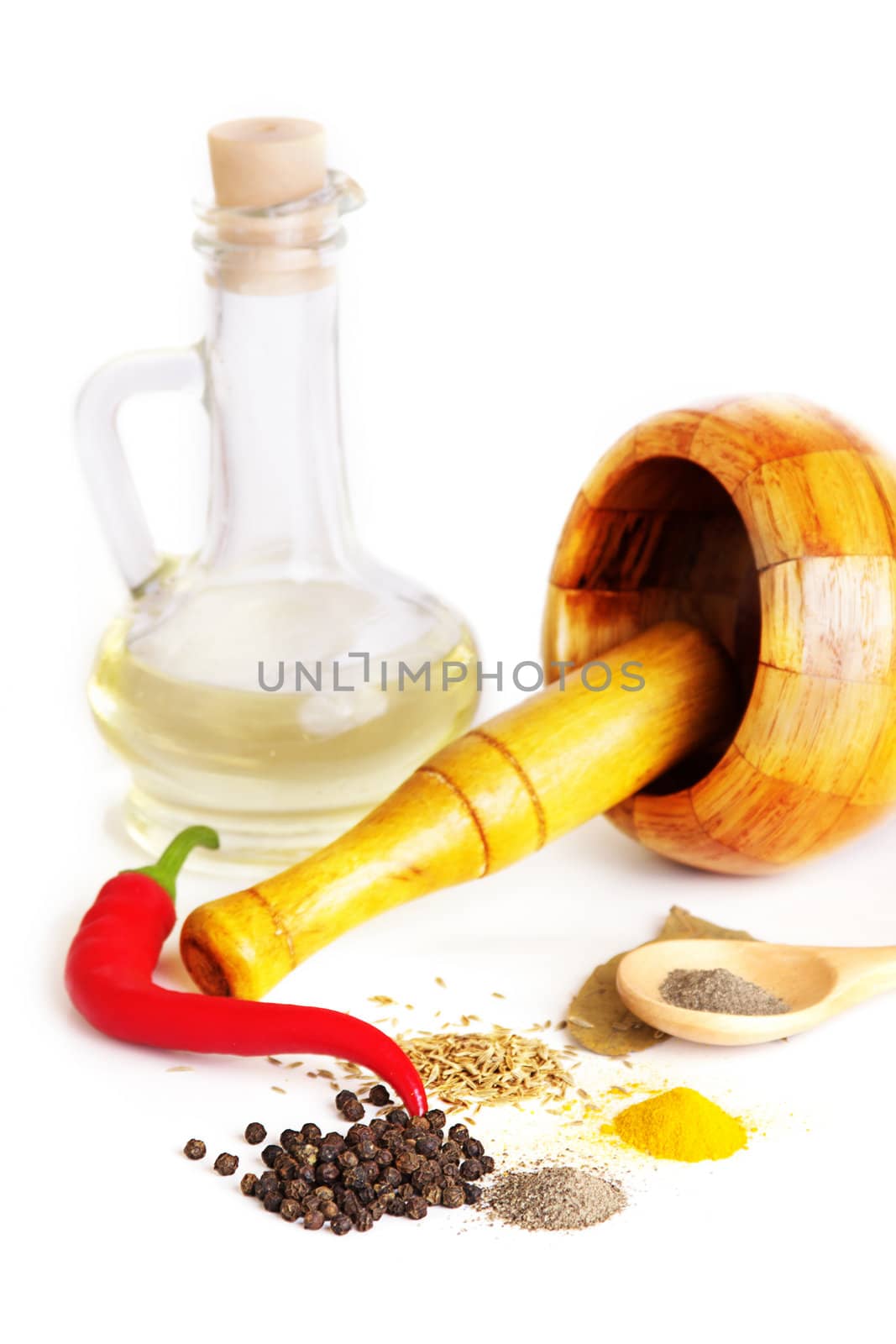 Mortar with pestle, variety of spices and oil by Angel_a