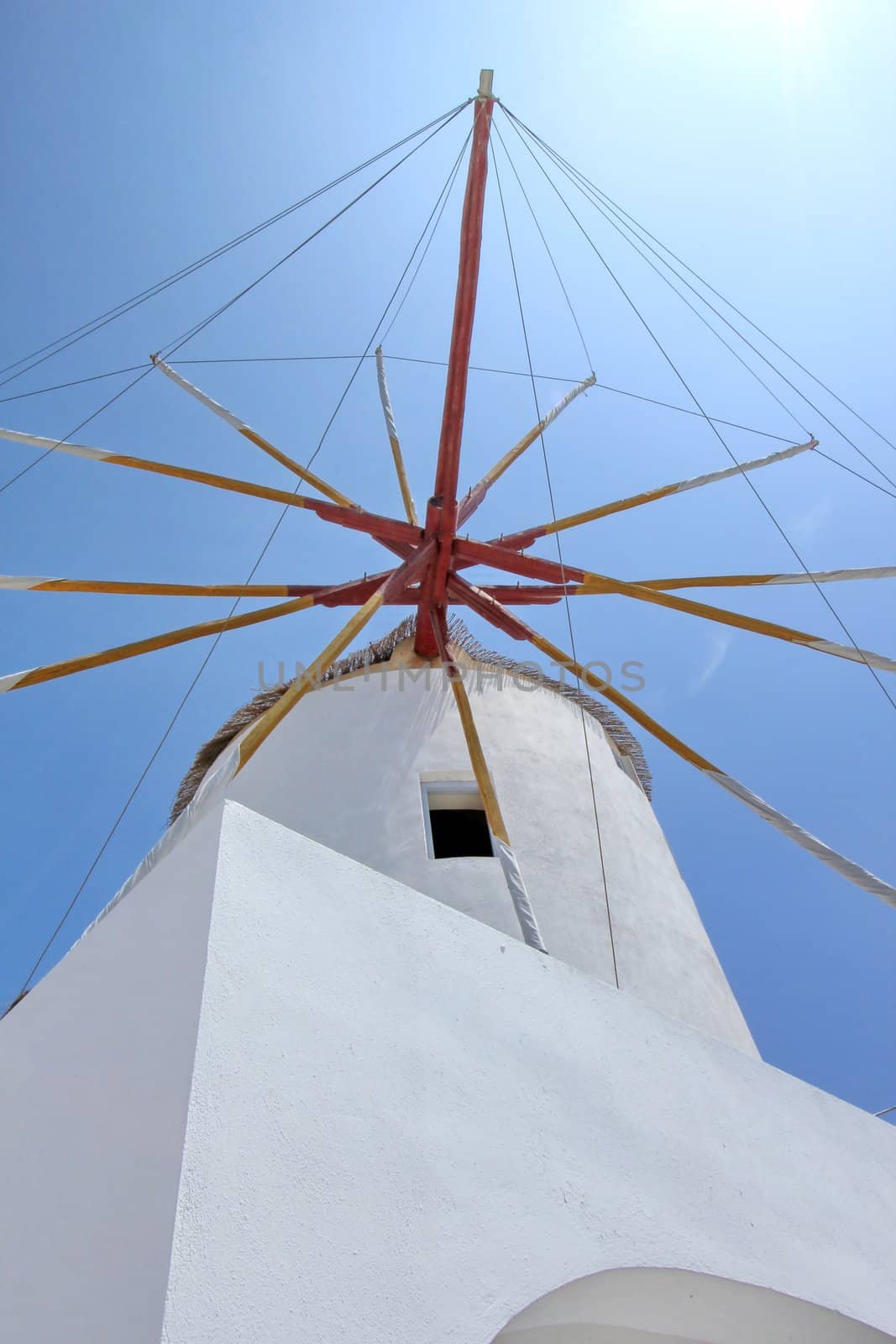 Famous old windmill at Oia, Santorini island, Greece, by sunny day