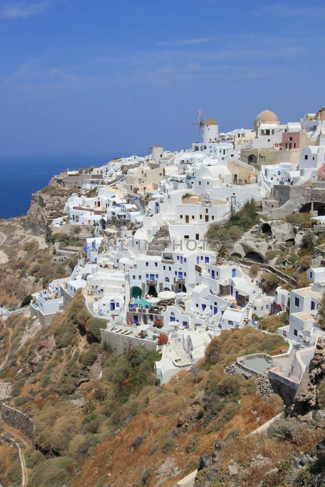 Overview on Oia village and its windmills on the island of Santorini, cyclades, Greece