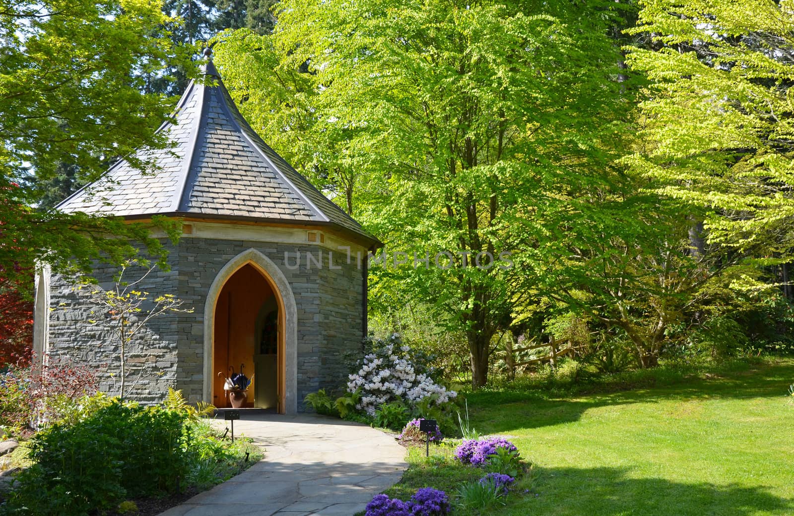 Brick gazebo in lush green garden setting