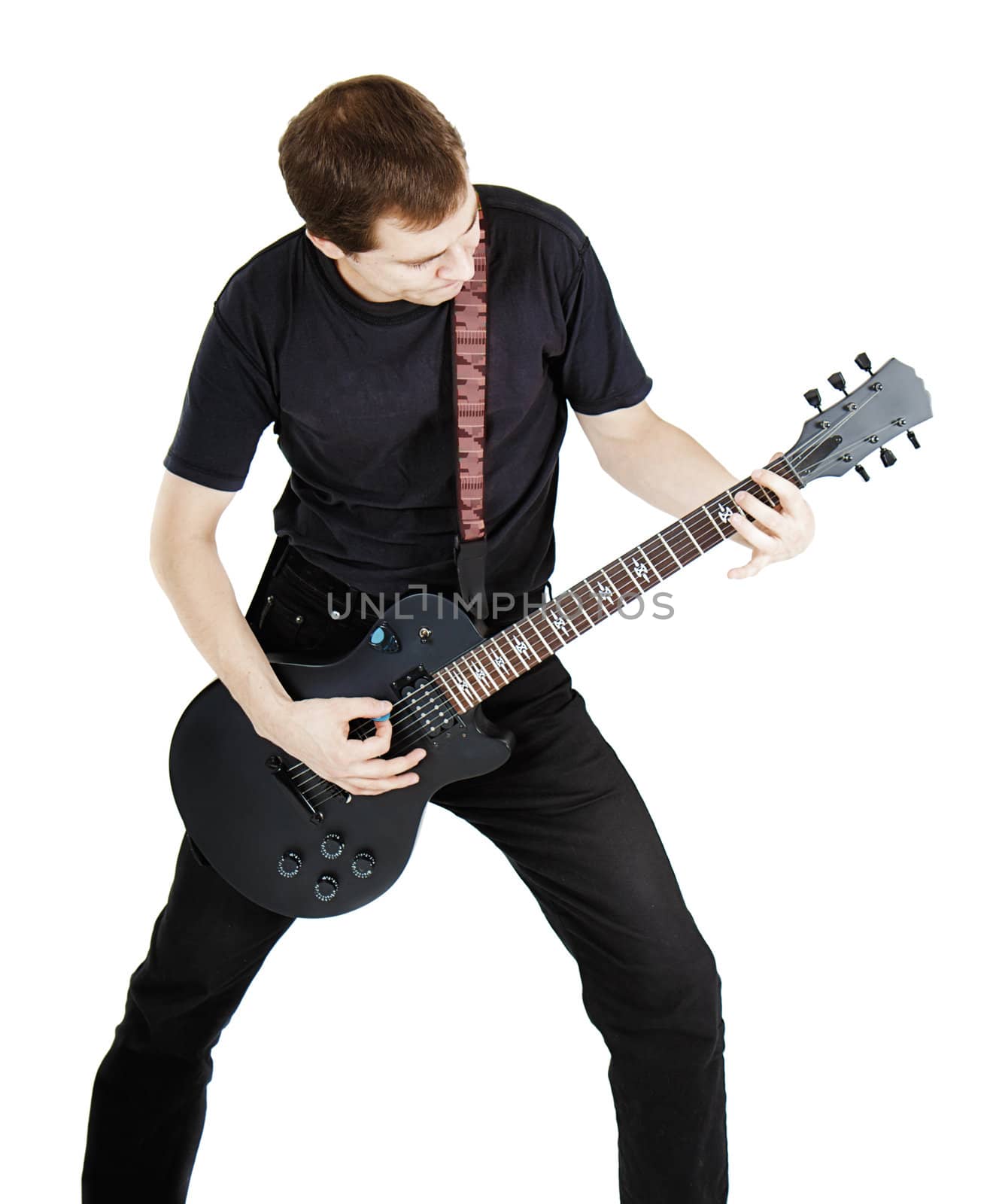 A young man dressed in black with electric guitar on white background