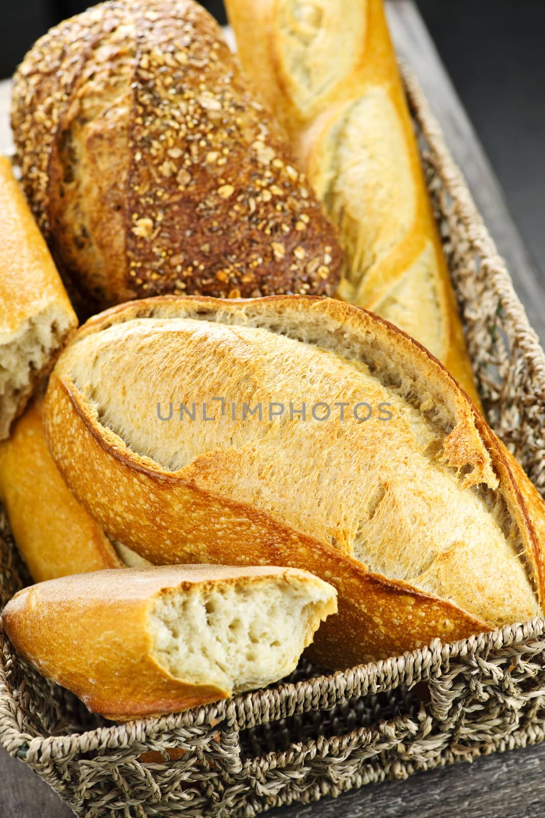 Various kinds of fresh baked bread in basket