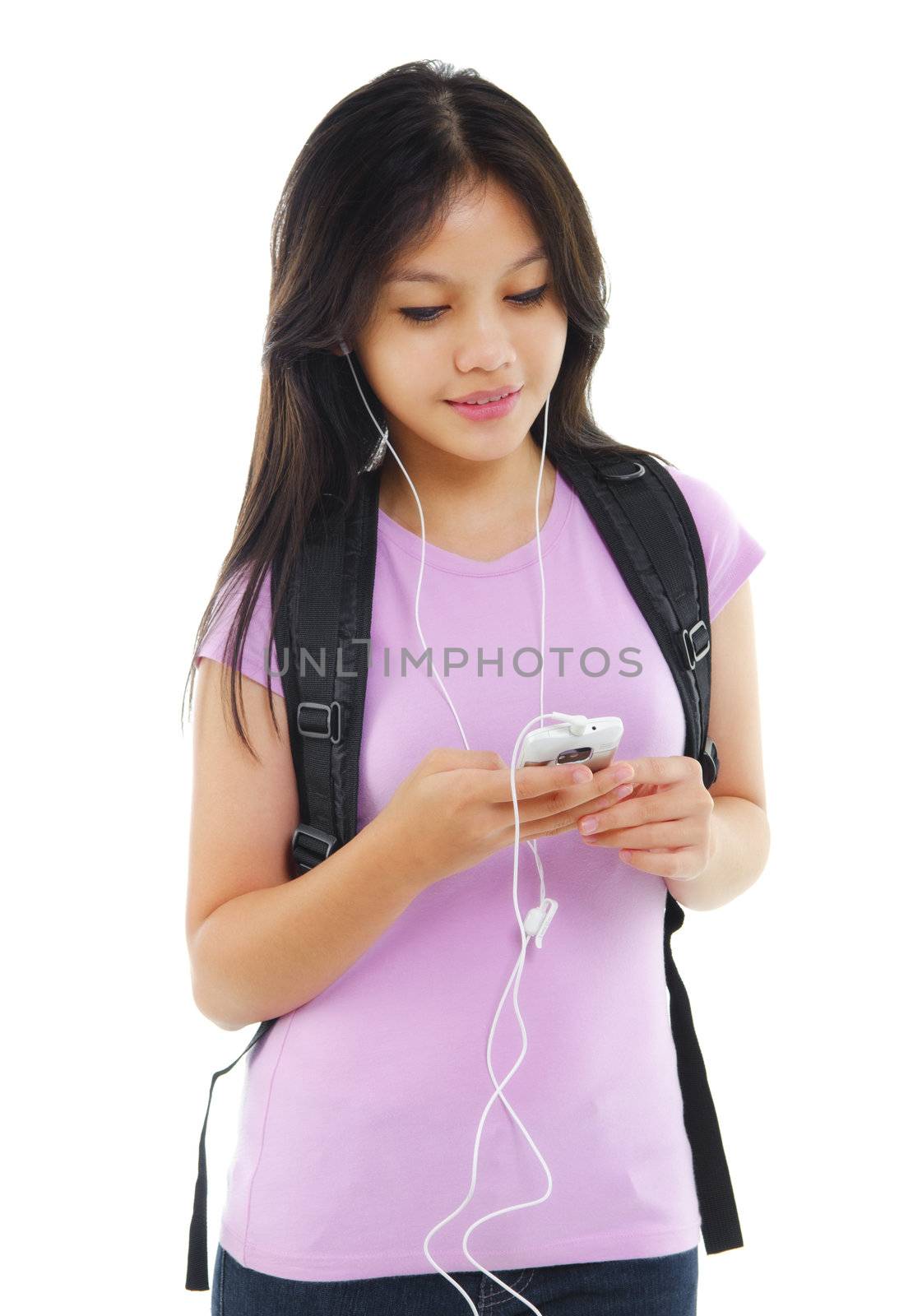 Young Asian teen texting and listening to music