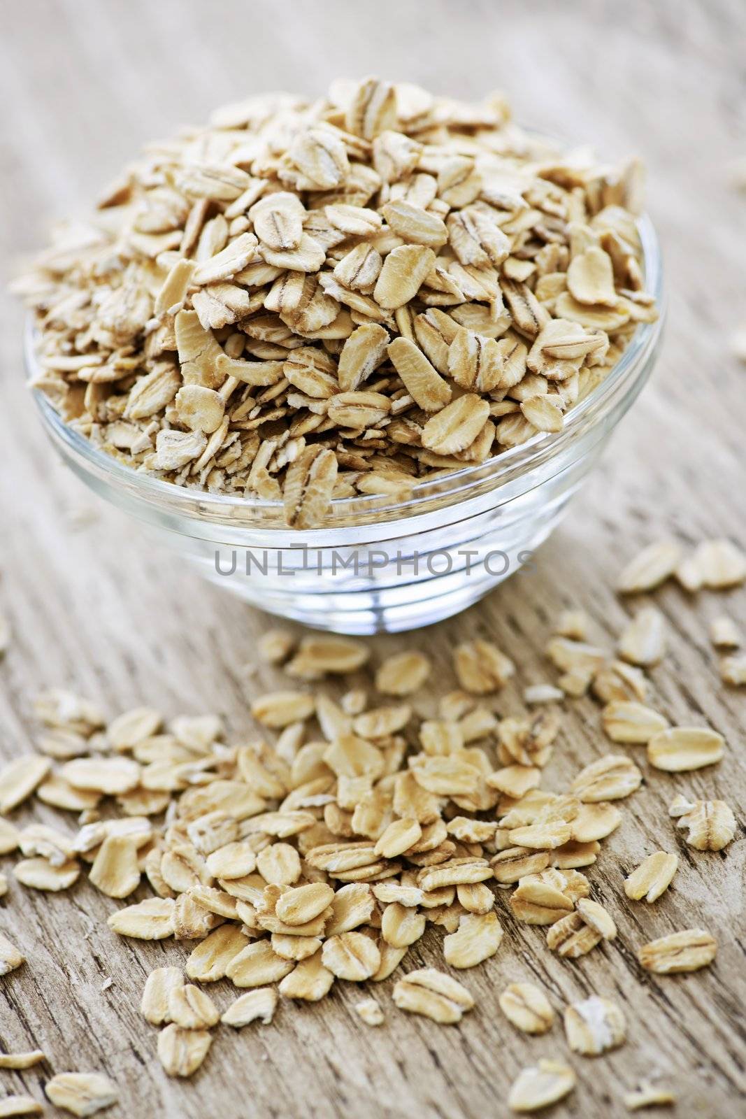 Nutritious rolled oats heaped in a glass bowl