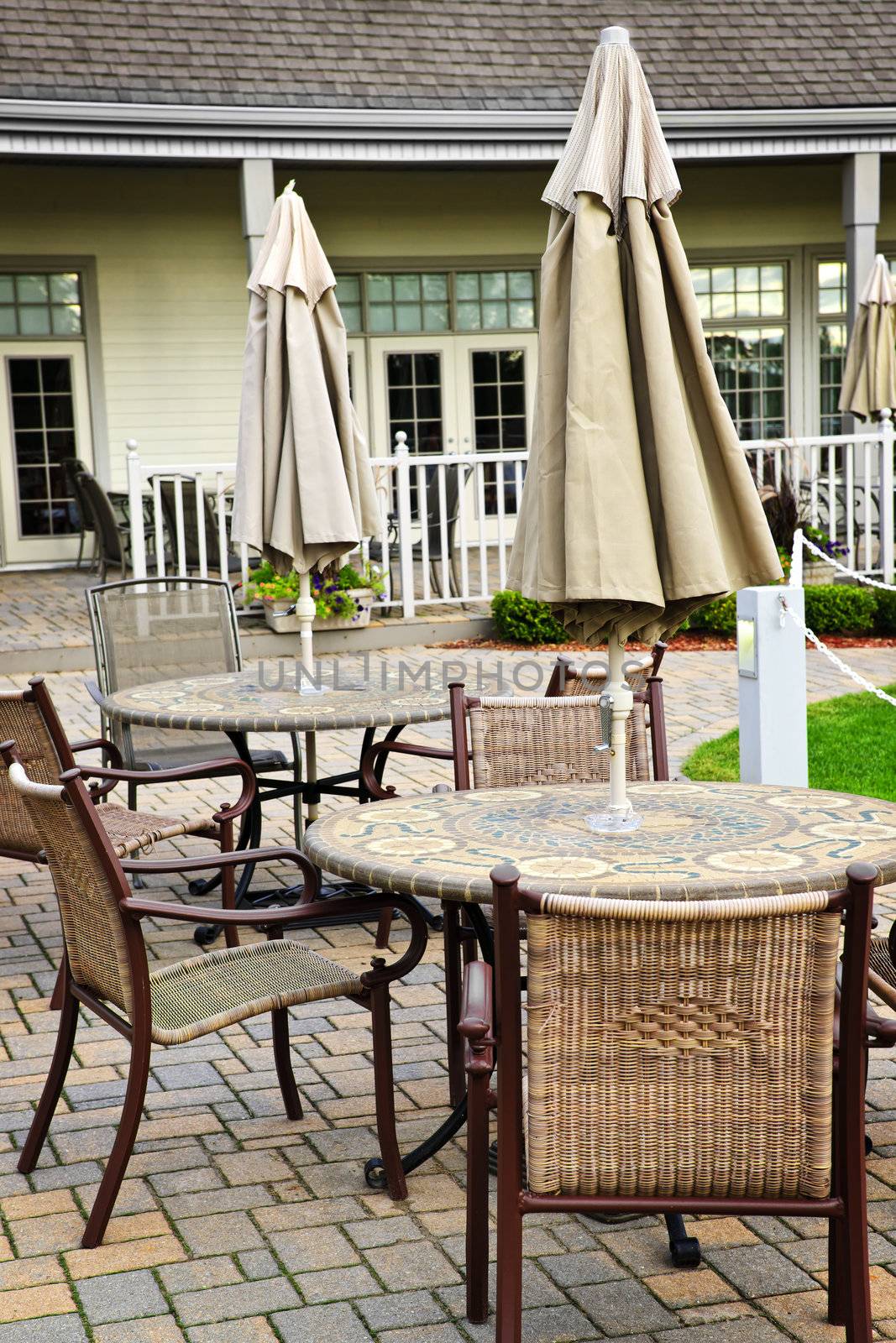 Patio furniture with tables chairs and umbrellas