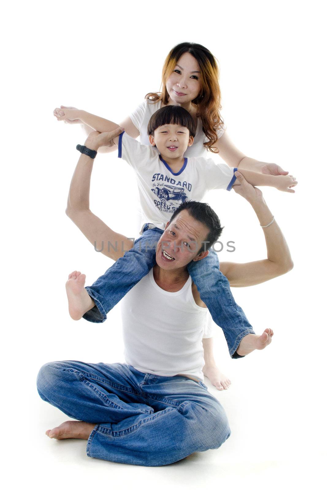 Happy Asian family stacking on white background