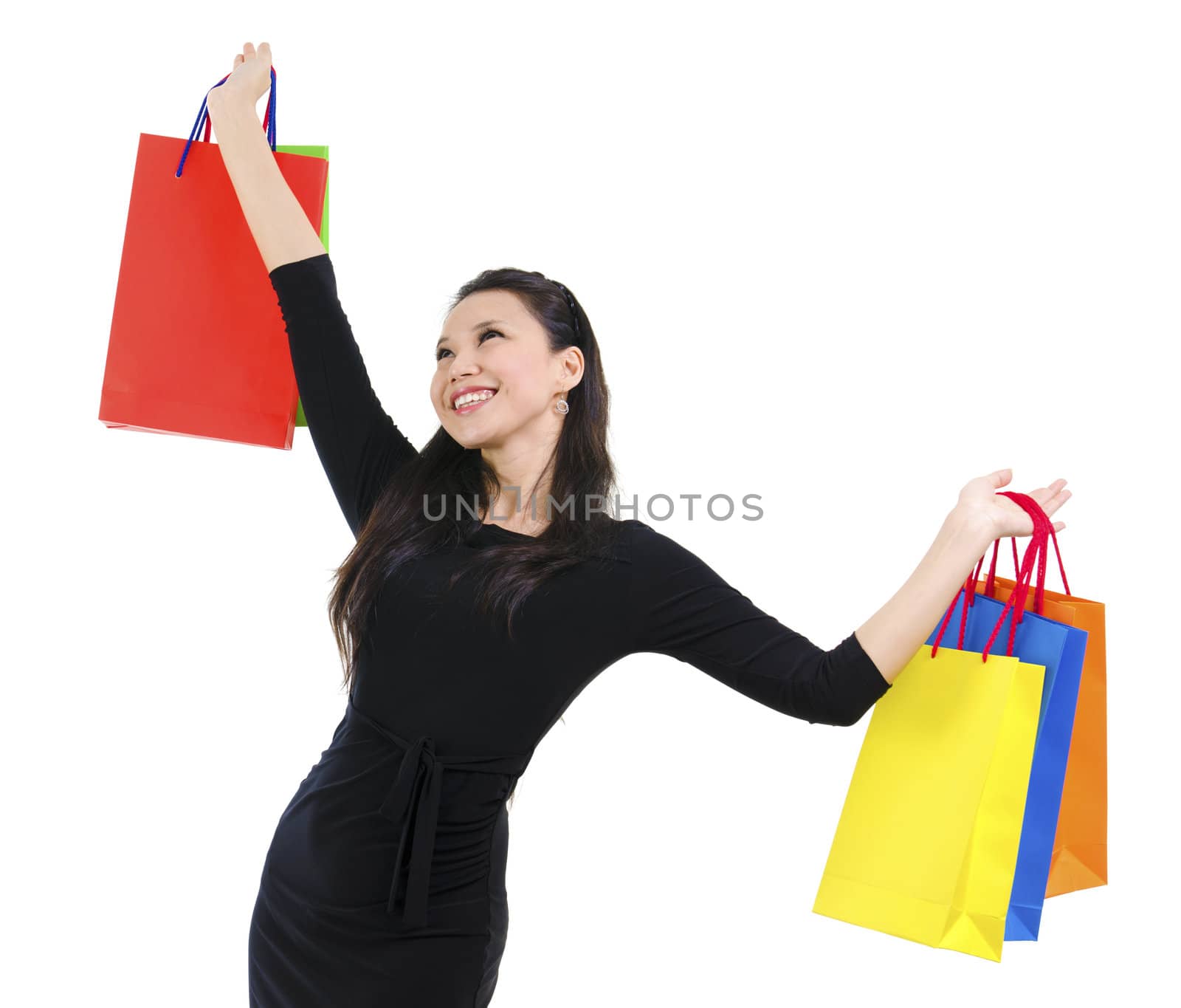 Happy shopper holding shopping bag high isolated on white background
