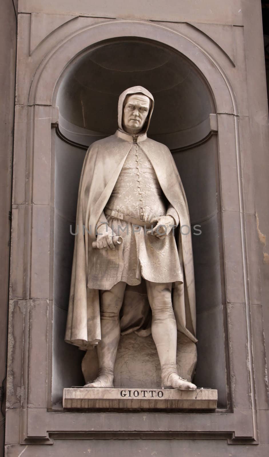 A statue of Giotto di Bondone sitting outside of the Uffizi, in Florence, Italy.  Giotto was a painter and architect during the Italian Renaissance.