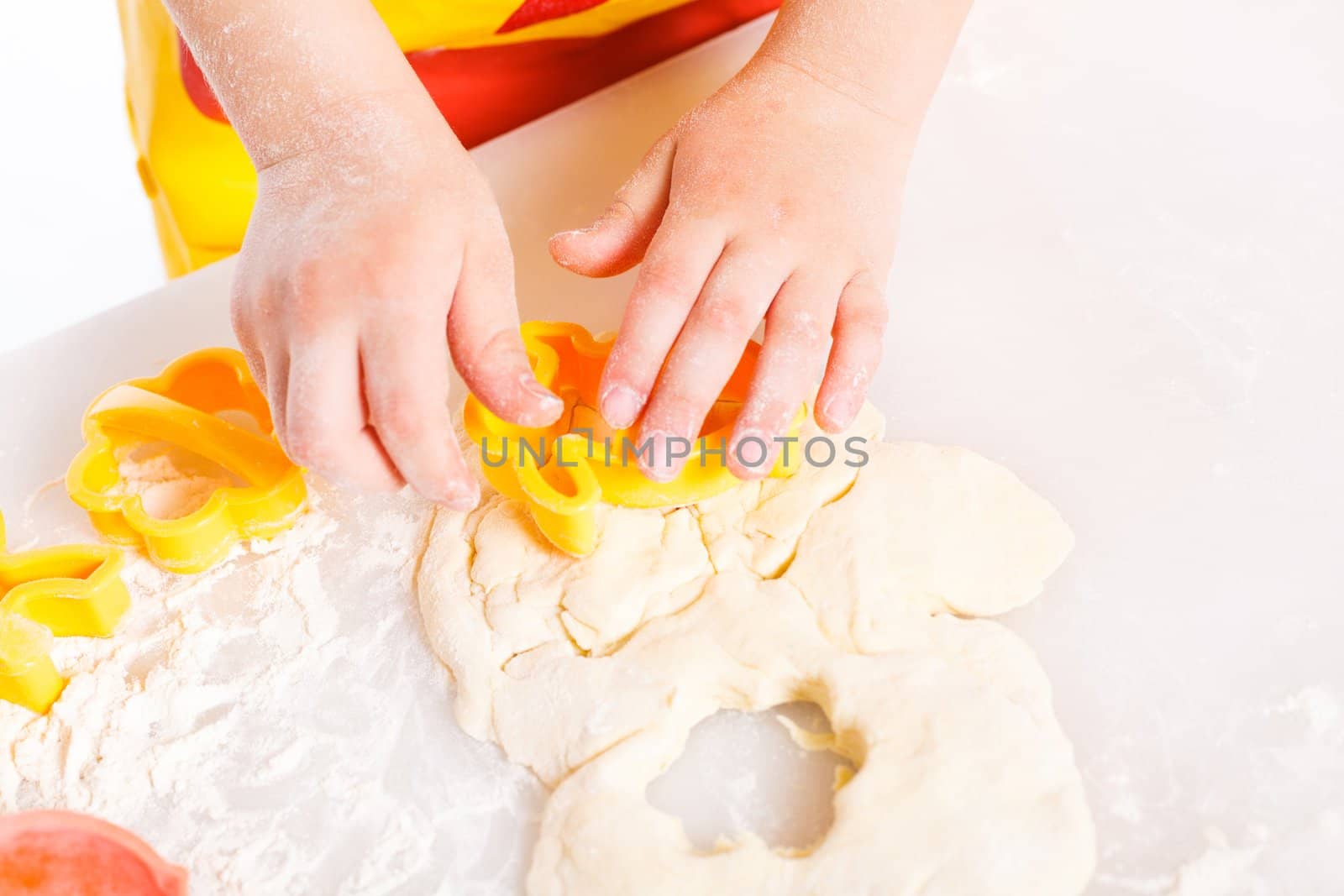 Beautiful hand boys making a cake, isolated on white background.