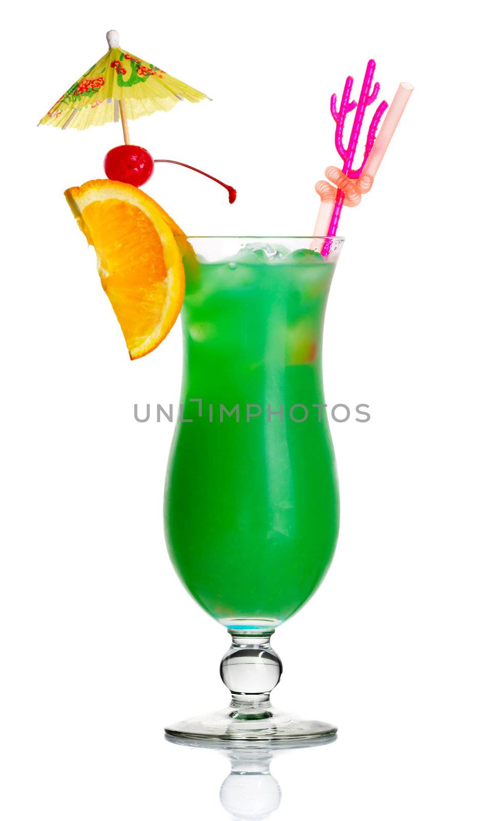 Green alcohol cocktail with orange slice and umbrella isolated on white background