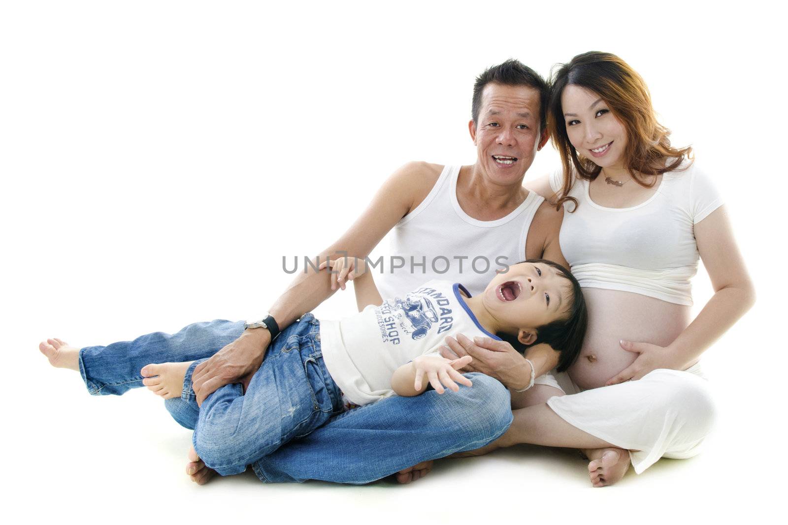 Asian family sitting on floor, white background