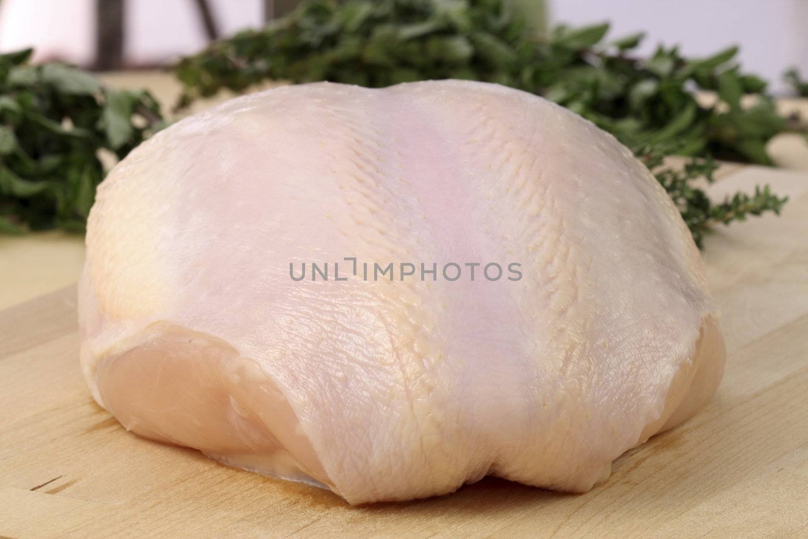 raw and juicy  turkey breast with herbs on background fresh and healthy food