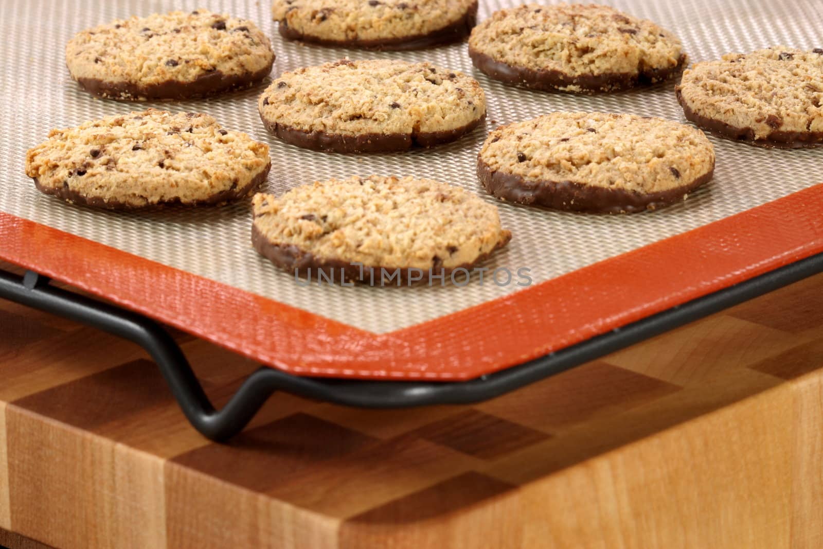 Fresh baked Stack of warm chocolate base and chips cookies on baking silicone sheet