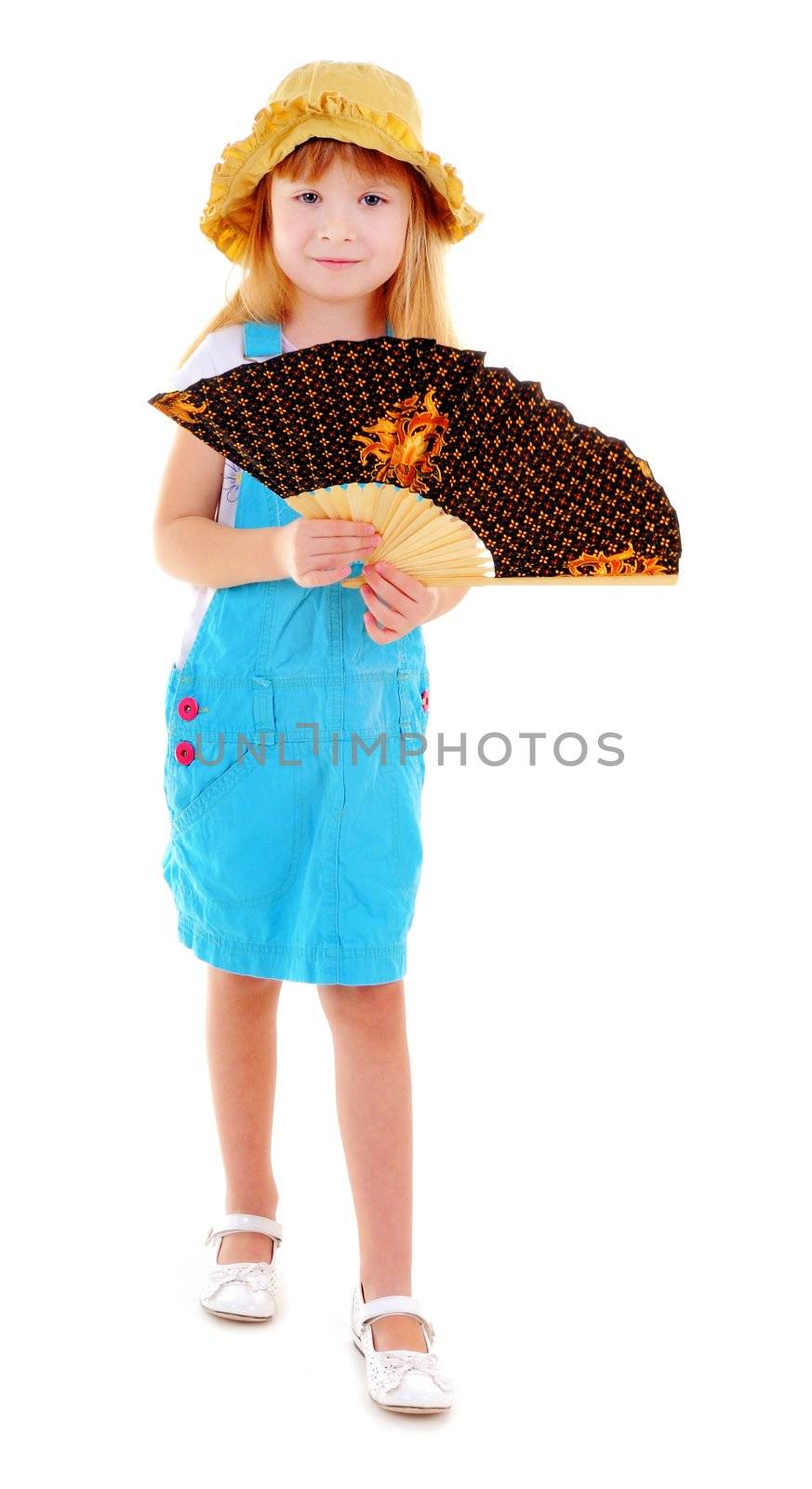 Nice girl in blue suit is playing with a fan on white background