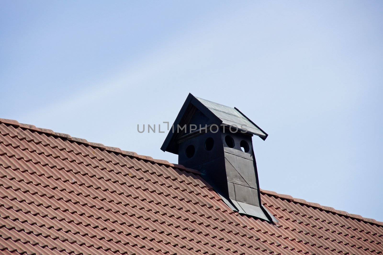 Pipe of ventilation on a roof of tiles