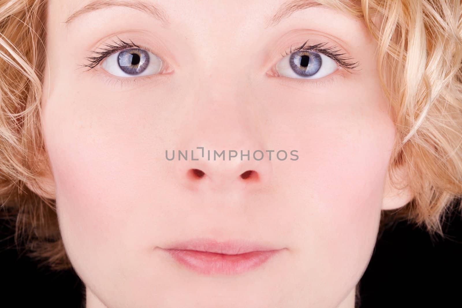 Closeup of a pretty blond girl's face with blue eyes