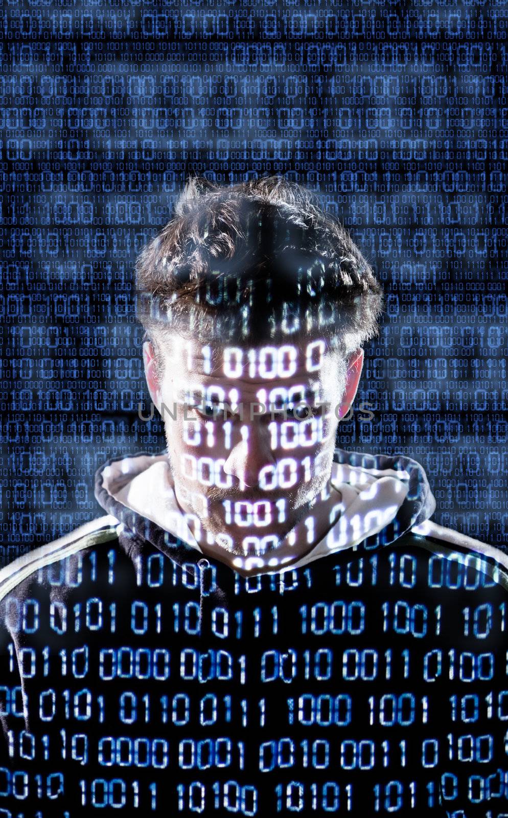 Hacker with binary codes looking directly to the camera