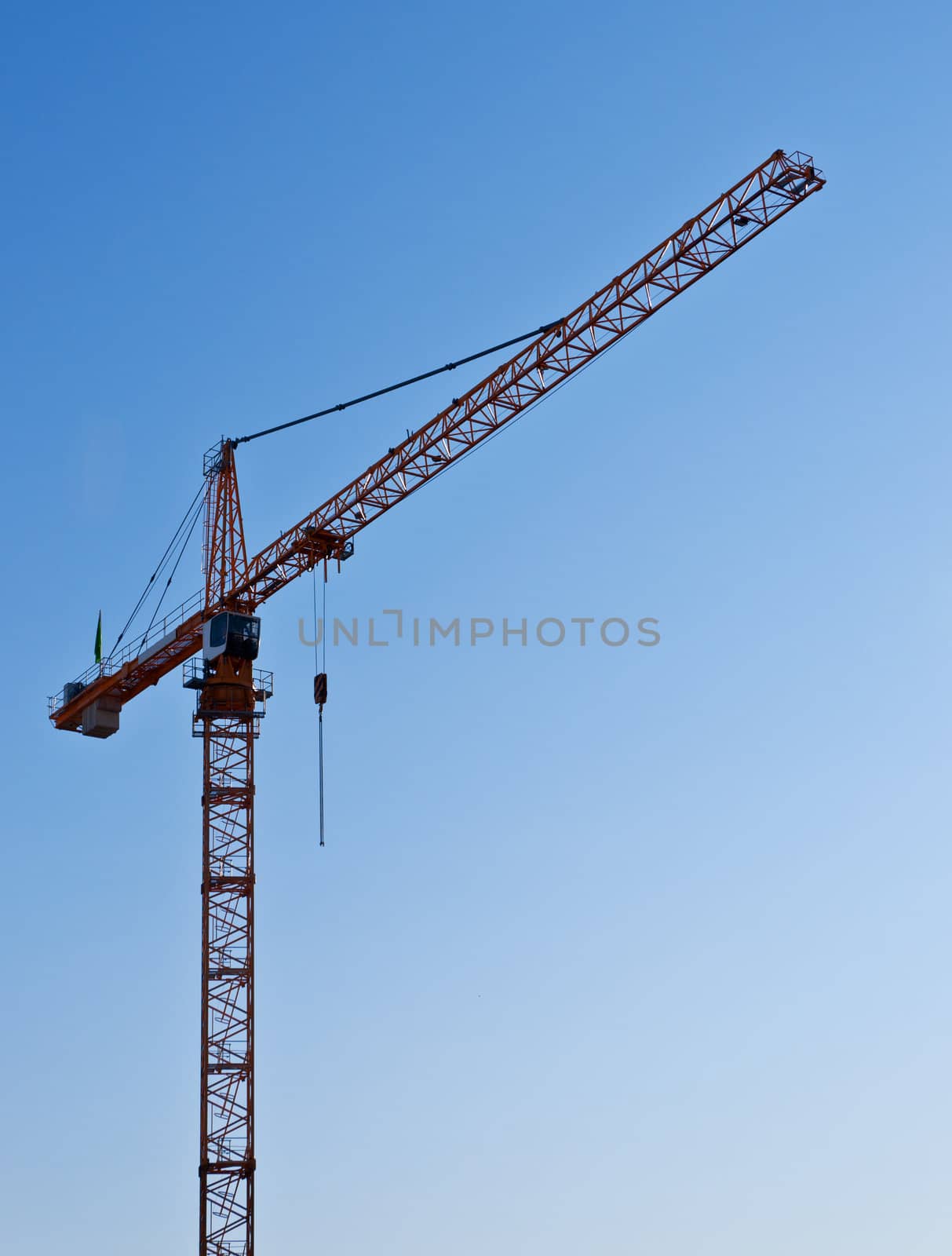 Hoisting crane on blue sky background