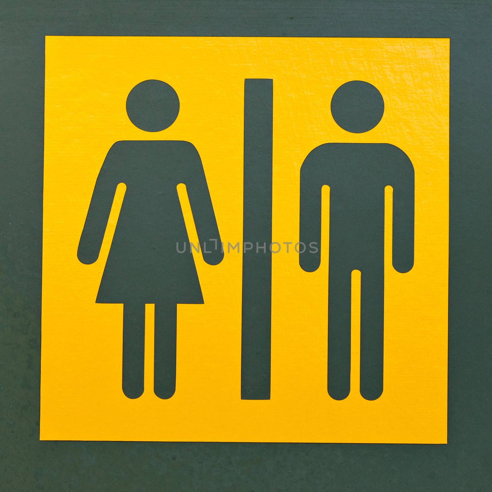 Signpost for men and women or male and female as often used to indicate restrooms with two silhouetted figures standing side by side on yellow