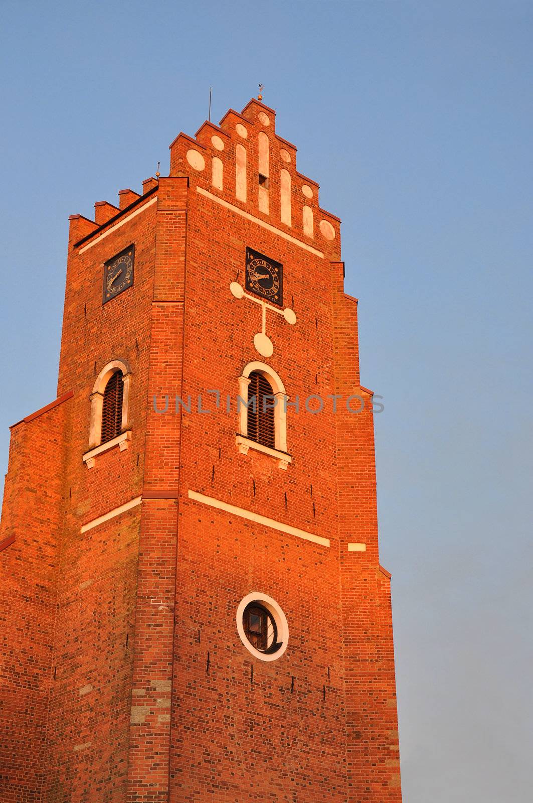 Red brick wall clock tower from the medieval period.