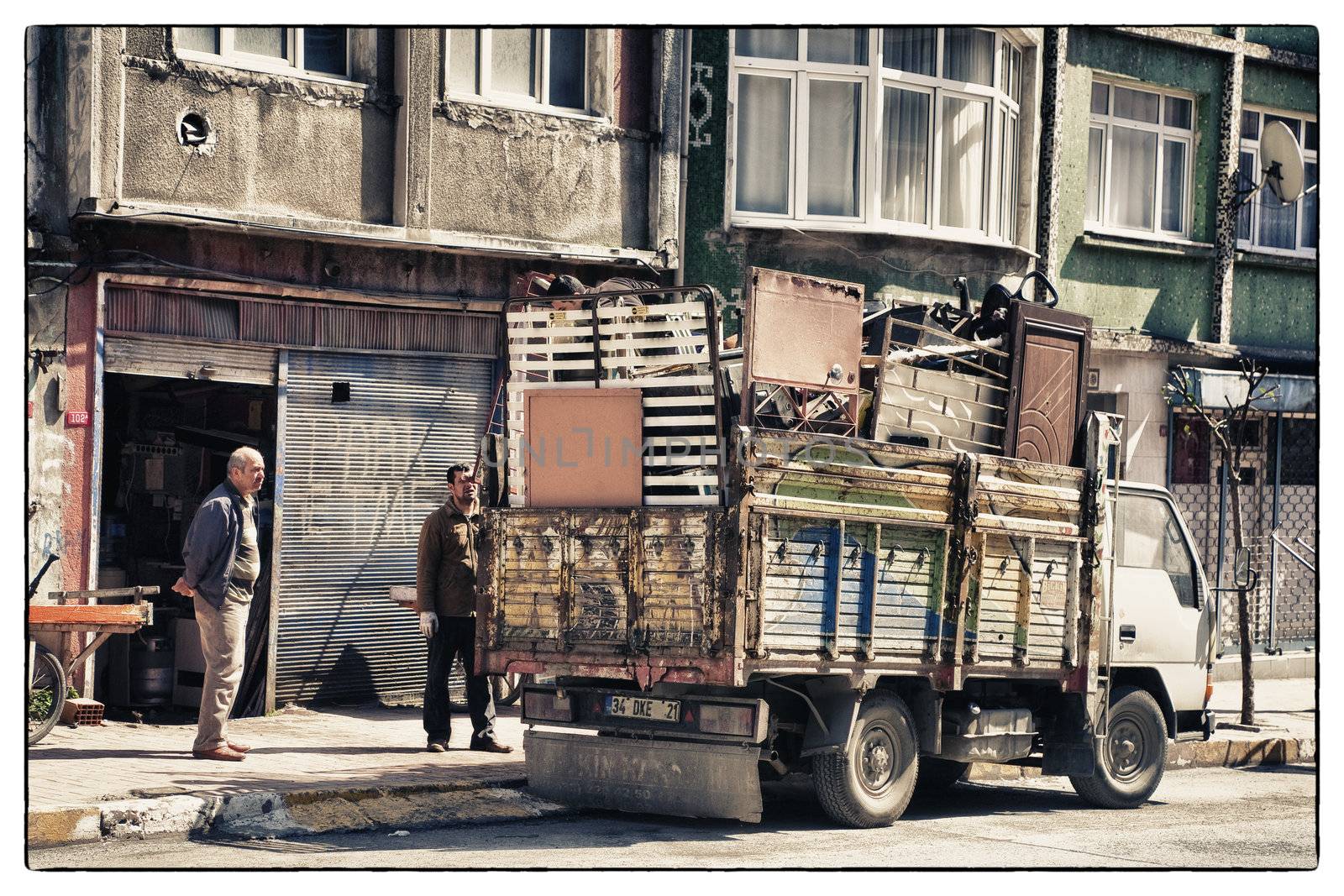 HEAVY LOADED TRUCK, ISTANBUL, TURKEY, APRIL 13, 2012: Scrap tradesman with high loaded truck in the Eyup area.